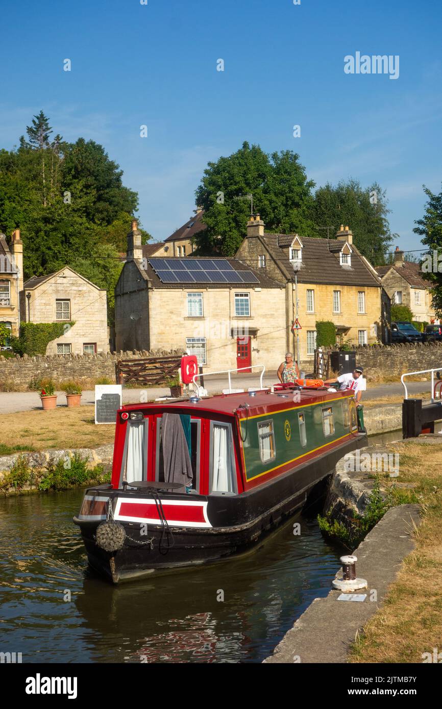 Canal narrowboat passing through Bradford locks on the Kennet and Avon canal at Bradford on Avon Wiltshire Stock Photo