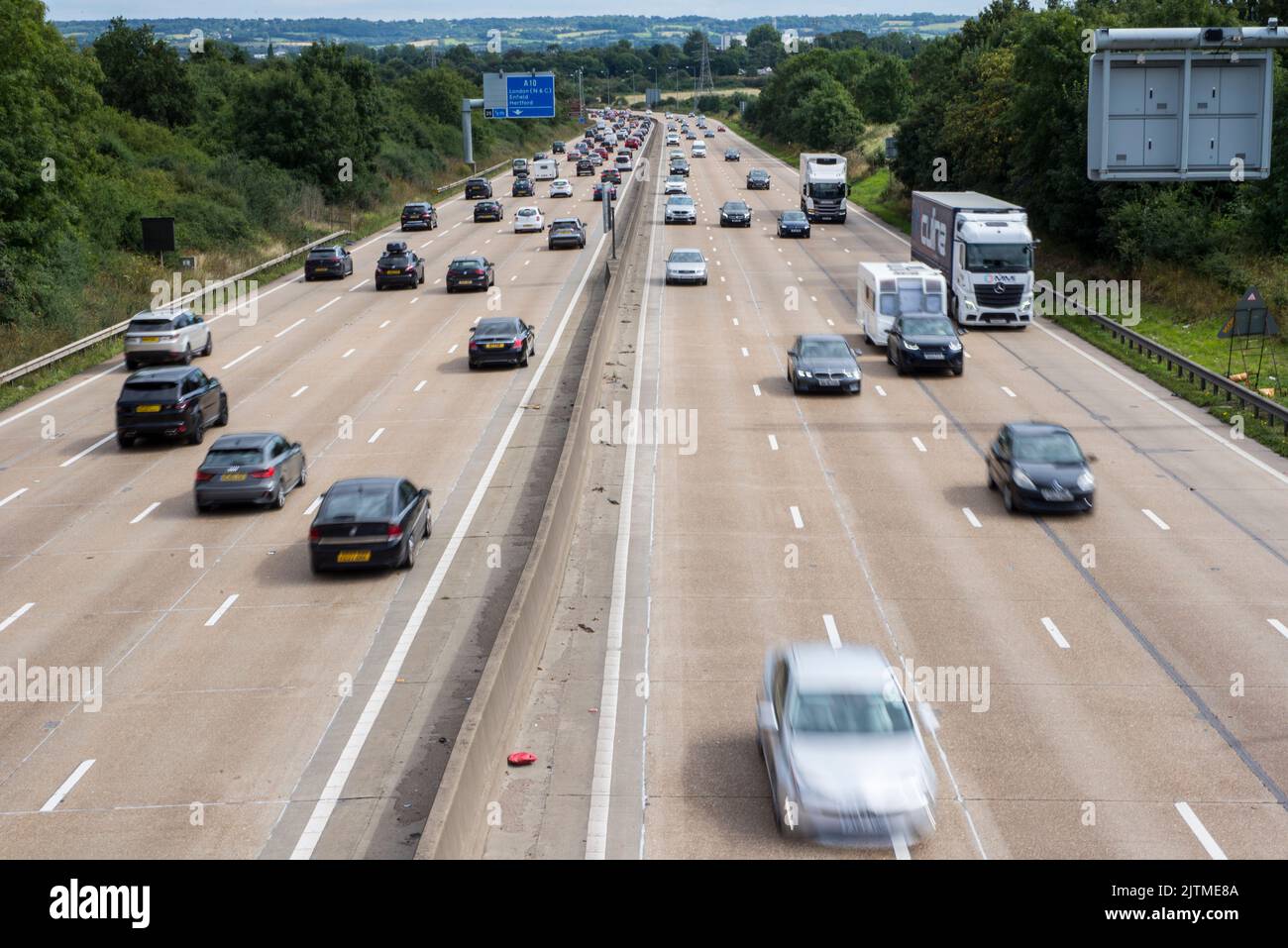 Cars and other vehicles moving along a British motorway at speed in Hertfordshire in the UK Stock Photo