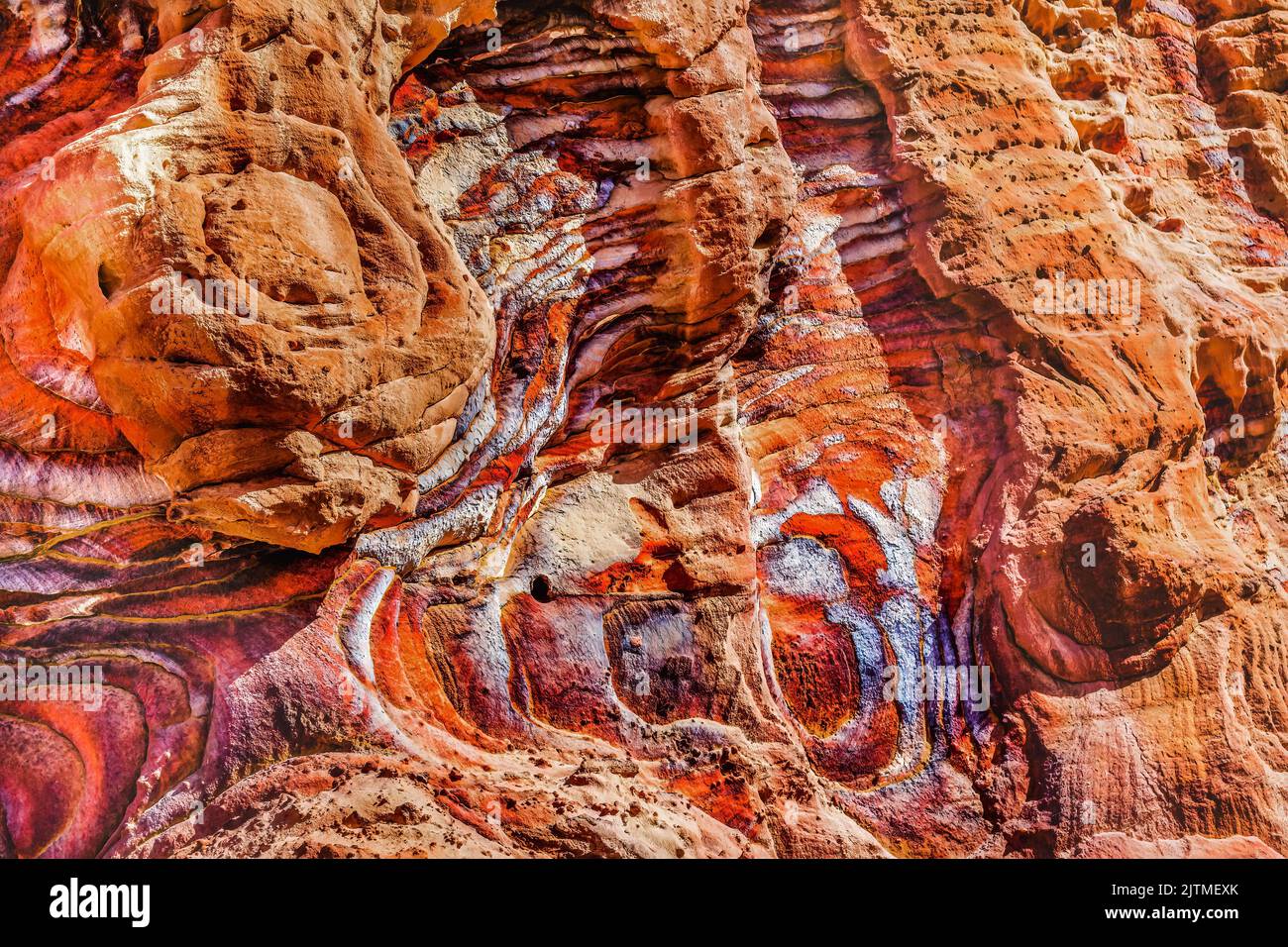 Red Rock Abstract Petra Jordan Built by Nabataens in 200 BC to 400 AD Red canyon walls create many abstracts close up Stock Photo