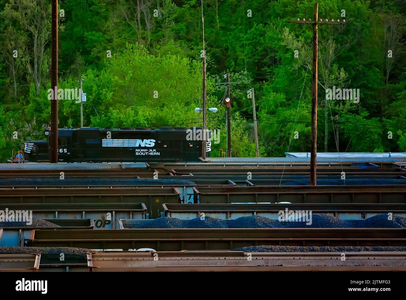 Norfolk Southern train 6165 passes railroad cars filled with coal at the Williamson railyard, April 28, 2010, in Williamson, West Virginia. Stock Photo