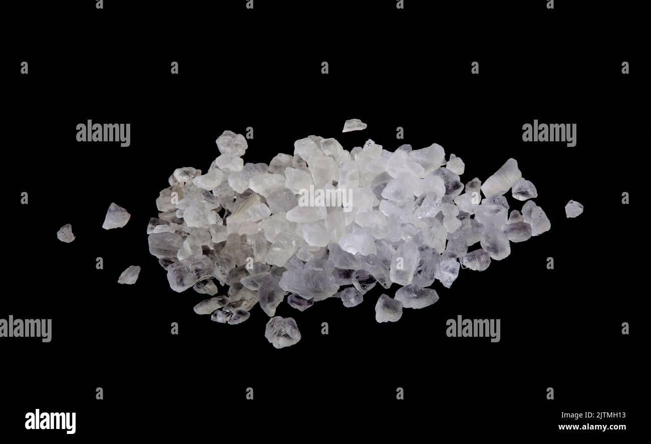 Natural rock salt is the mineral form of sodium chloride called Halite, typically colorless or white, occurring within sedimentary rocks and formed fr Stock Photo