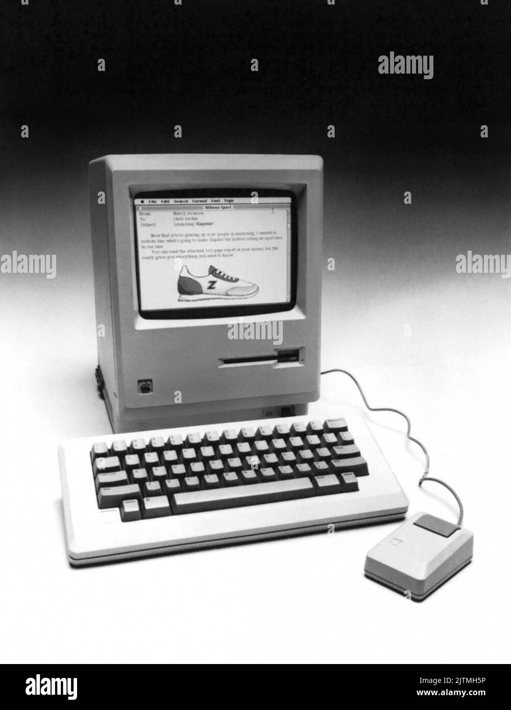 Apple Computer's January 1984 publicity photo of their brand new Macintosh computer. Apple announced the new Macintosh as having a 32-bit microprocessor, a built-in 3.5 inch disk drive, a 9-inch black-on-white display, 64k of ROM and 128k of RAM, as well as a detachable keyboard and a mouse pointing device. Suggested retail price - $2,495. Stock Photo