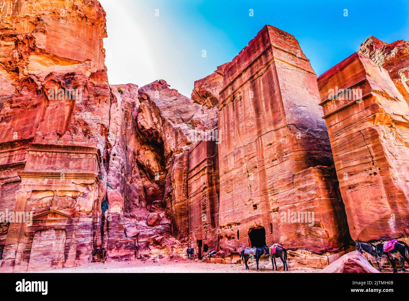 Rose Red Rock Tomb Afternoon Donkeys Street of Facades Petra Jordan Built by Nabataens in 200 BC to 400 AD  Afternoon turns yellow canyon walls in to Stock Photo