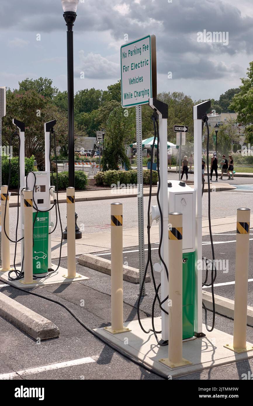 A bank of electric car charging stations in Salisbury, Maryland offers a waived parking fee while charging vehicles. Stock Photo