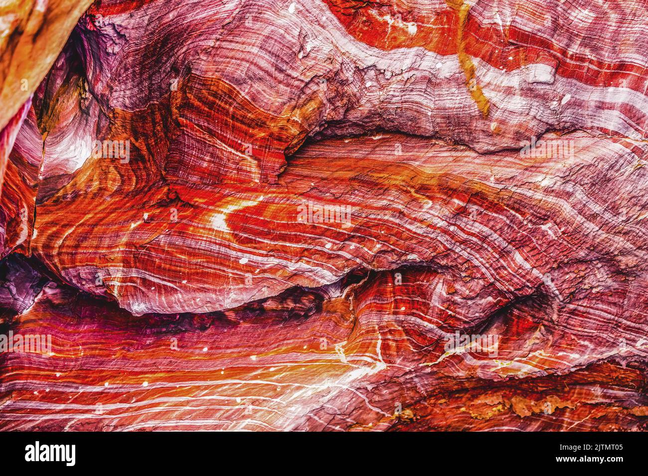 Red Rock Canyon Wall Abstract Petra Jordan Built by  Nabataens in 200 BC to 400 AD Canyon walls create many colorful abstracts close up Stock Photo