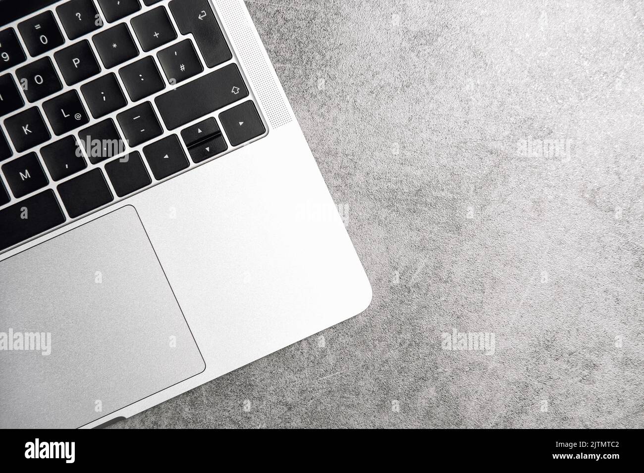 Laptop notebook keyboard on grey background. Office workspace flat lay Stock Photo