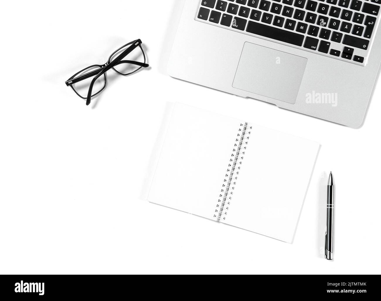Office workplace flat lay background. Laptop, notebook, glasses on white Stock Photo