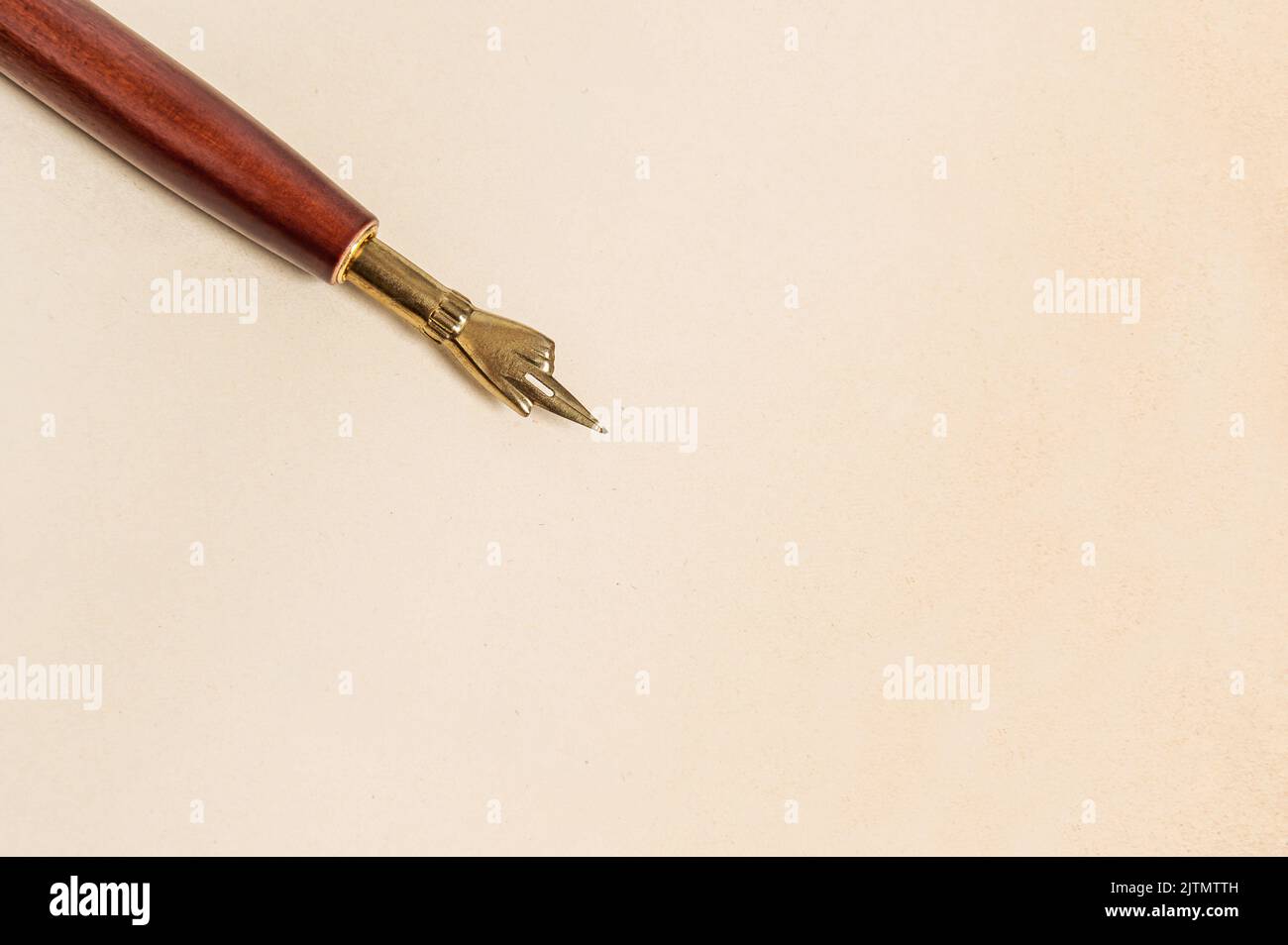 Antique ink pen on aged paper texture. Vintage style background Stock Photo