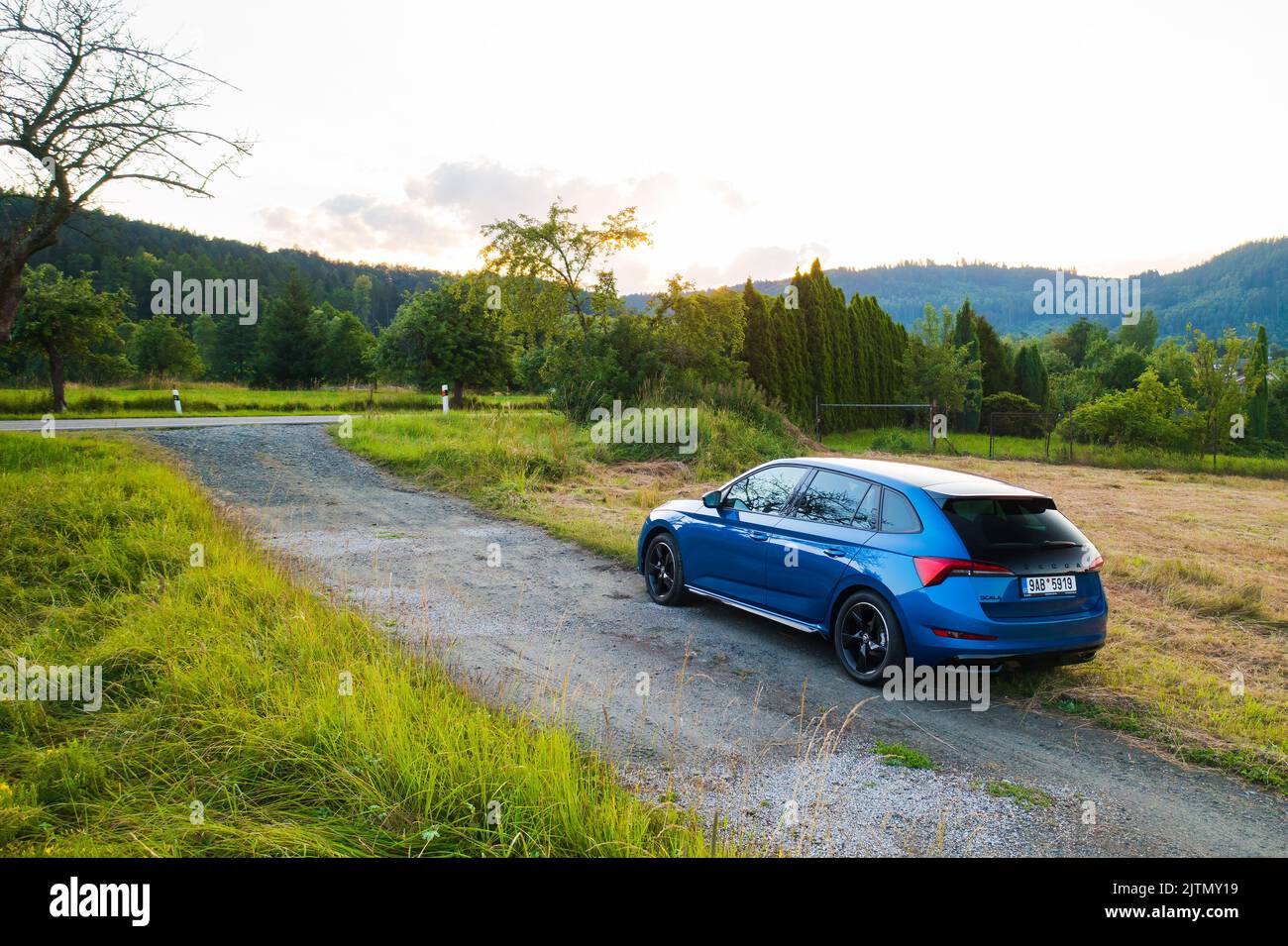 Off road traveling in blue Skoda Scala car at countryside road at sunset, August 2022, Dolni Morava, Czech Republic Stock Photo