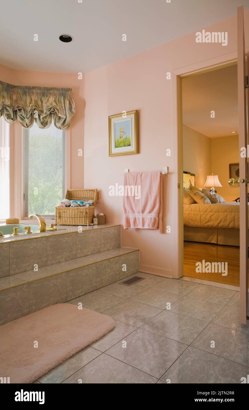 Bathroom with opened door leading to main bedroom inside modern home ...