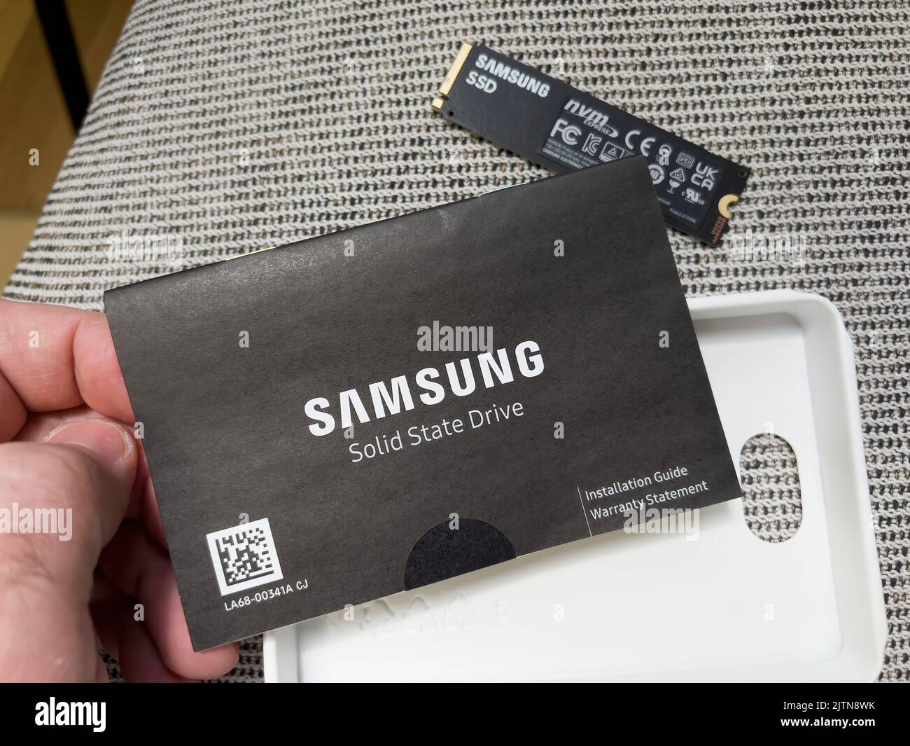 Paris, France - Aug 8, 2022: POV male hand reading after unboxing new Samsung 980 Pro NVME ssd hard disk drive for the personal computer or mac Apple upgrade Stock Photo
