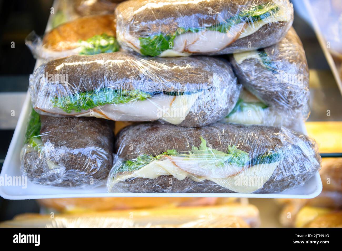 Delicious sandwiches with brown bread ham and cheese and lettuce salad