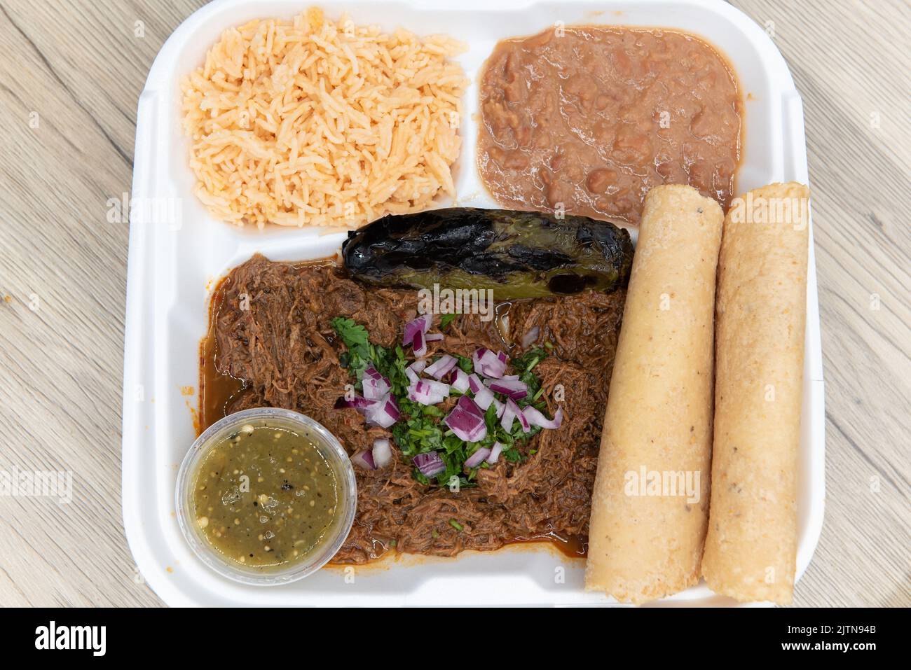 Overhead view of generous serving of slow cooked birria meat, served