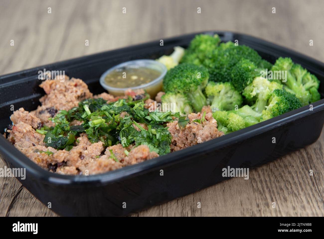 Take out order of ground turkey with rice and broccoli is conveniently packed in a microwavable container. Stock Photo