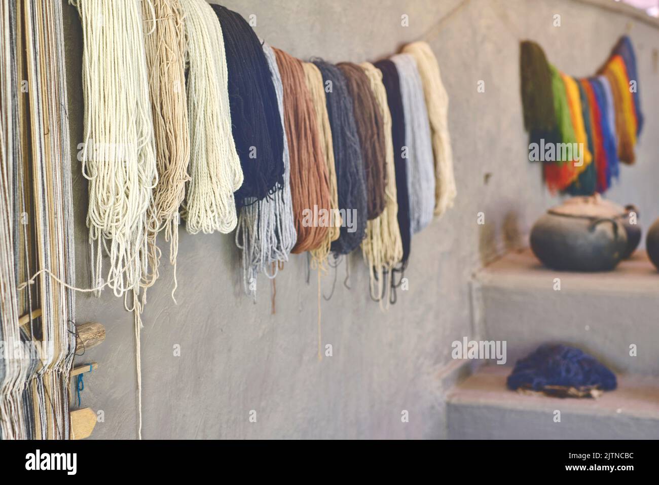 Stretched alpaca yarn being prepped for making clothing. Alpaca Wool Production in Peru, Selective focus. Stock Photo