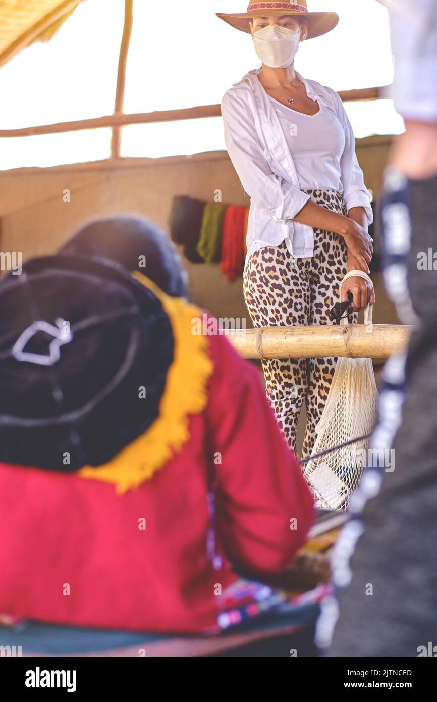 Indigenous woman showing traditional weaving technique and textile making in the Andes mountain
