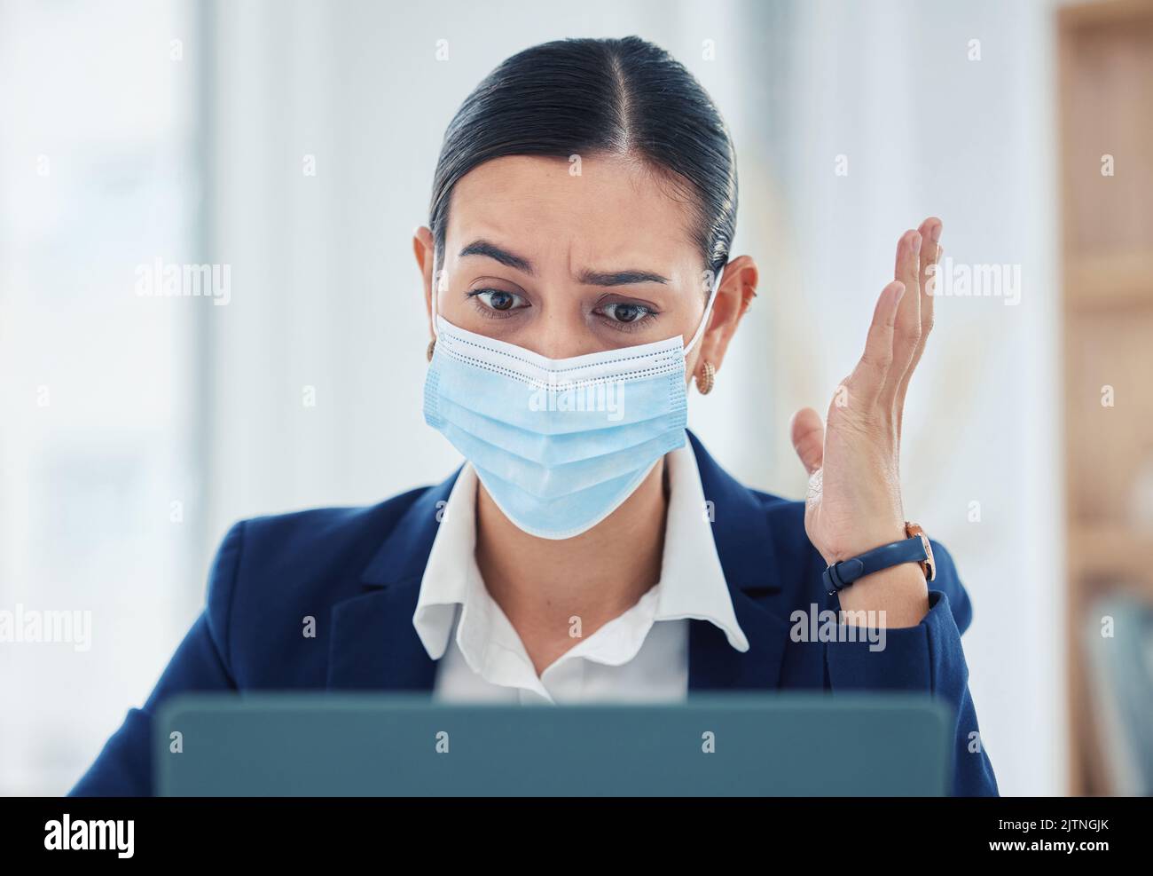 Covid, stress and a business woman at a laptop with face mask. Risk, compliance and corporate frustration, angry and confused by work email on Stock Photo