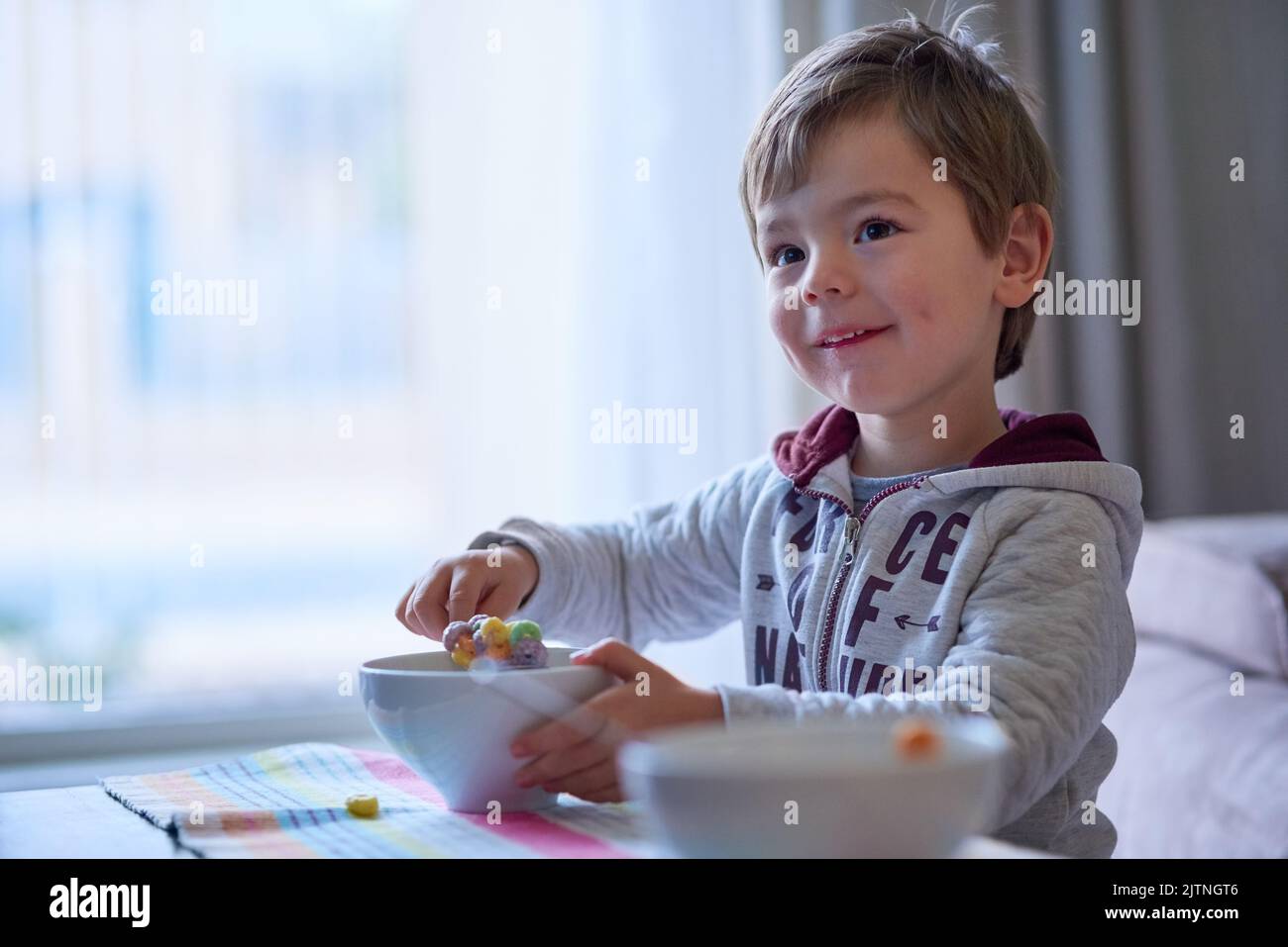 Its really yummy. a little boy eating breakfast at home. Stock Photo