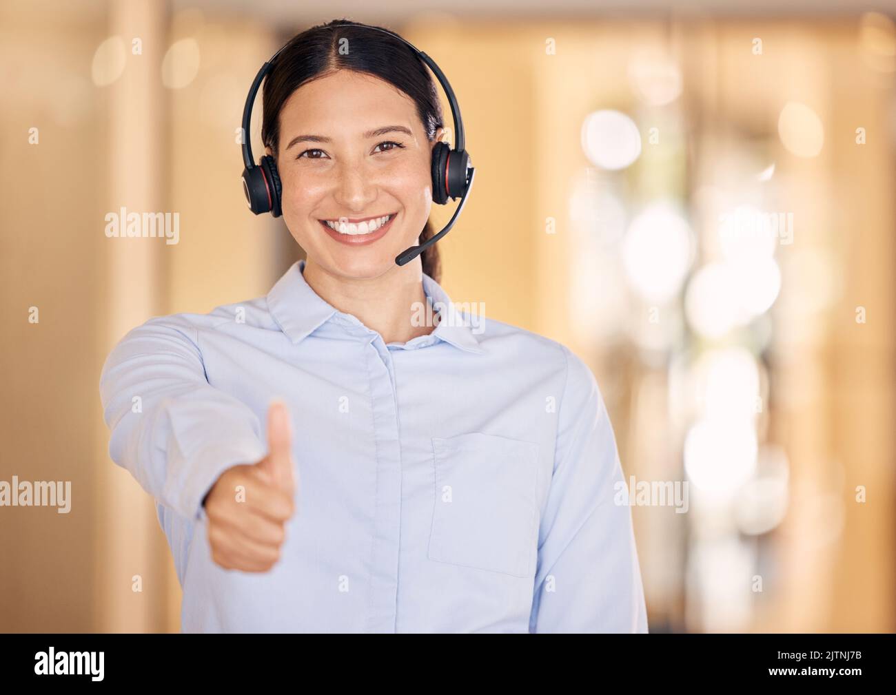 Woman thumbs up of crm, customer support and telemarketing agent. Success, achievement and support yes hand sign of a happy internet call center Stock Photo