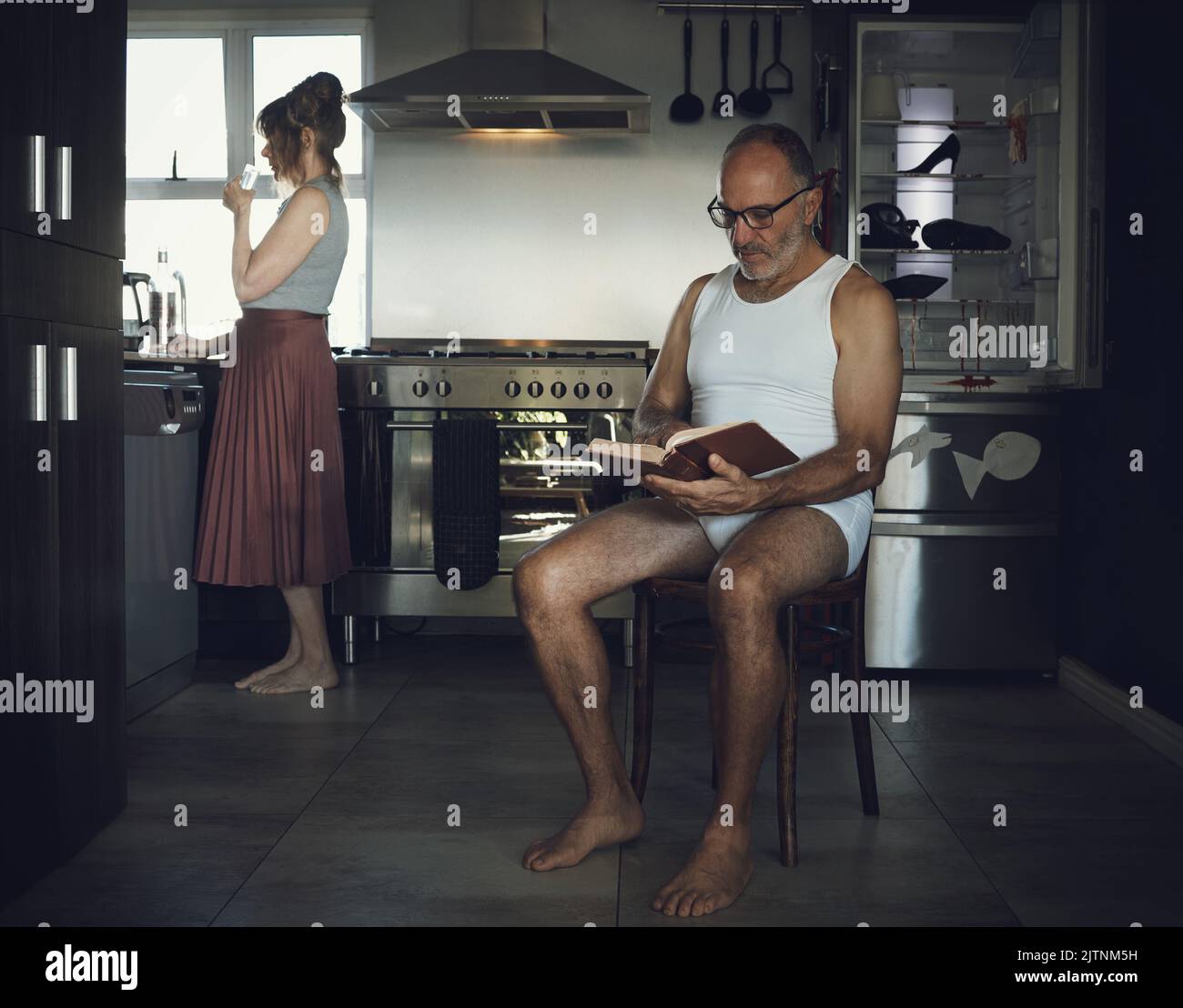 Marriage, problem and mental health issue with bored old couple in toxic, dark or sad family home kitchen together. Divorce, alcoholic and depression Stock Photo