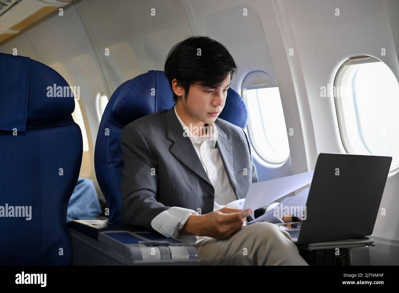 Professional and successful young Asian businessman working, managing ...