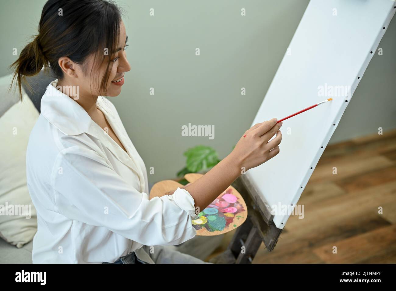 Talented and professional Asian female painter or artist designing her