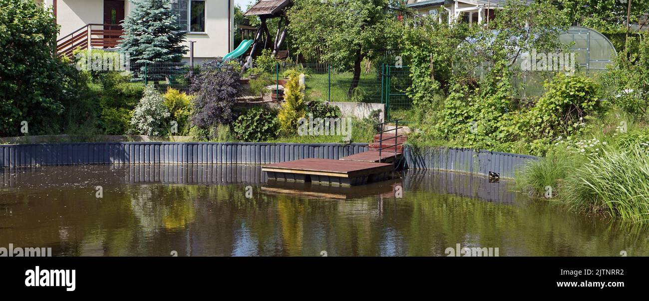 Homemade pond and pier in Lithuanian village Stock Photo