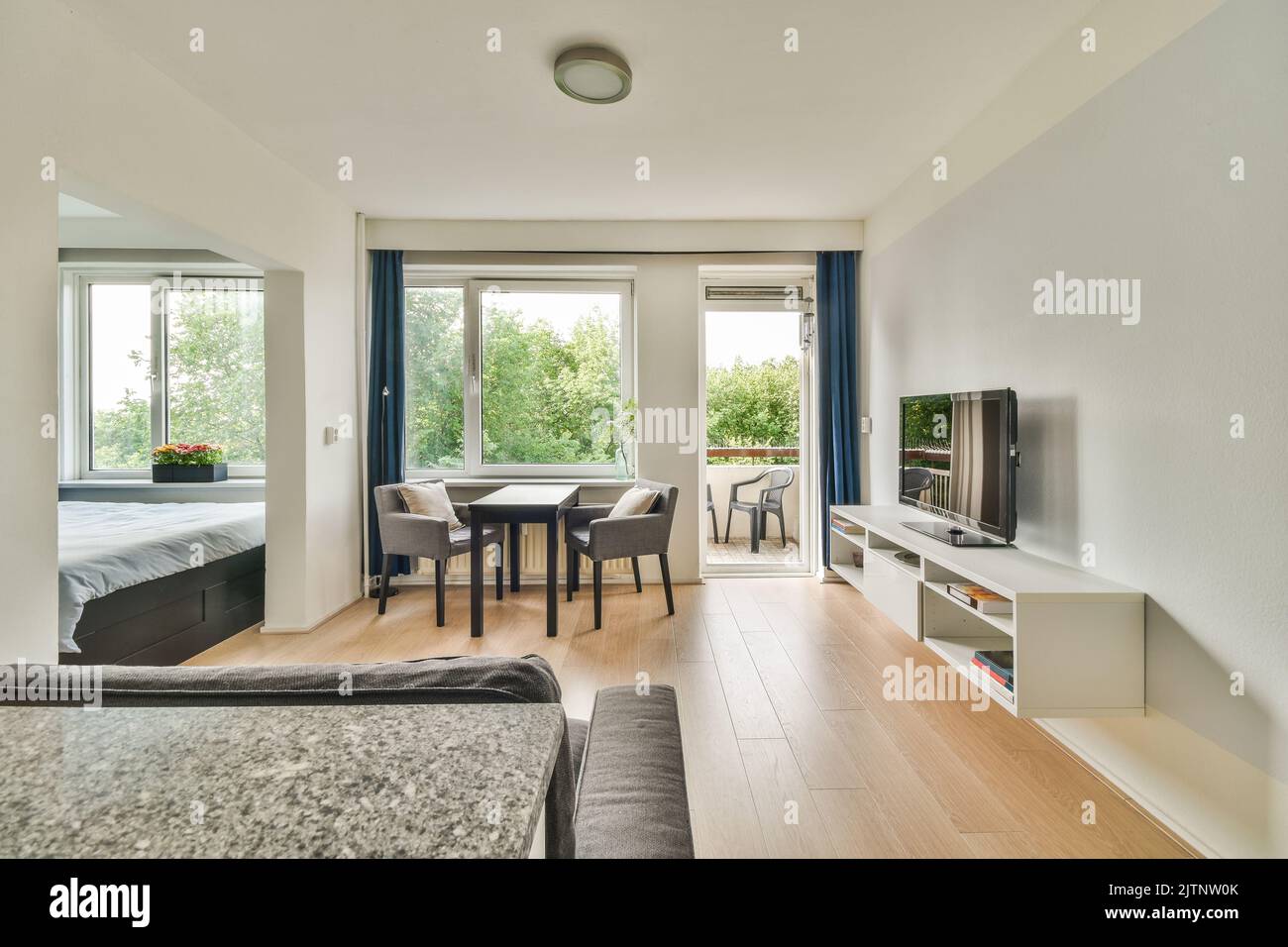 Interior of light room with stylish dining and lounge areas in modern