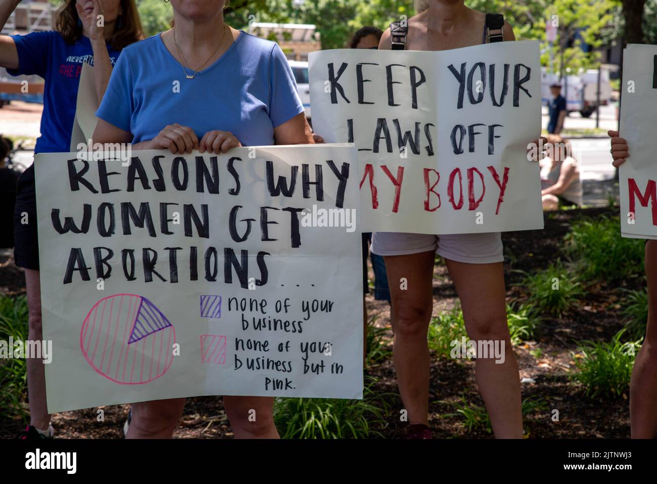 Women hold pro-choice protest signs at a political rally Stock Photo