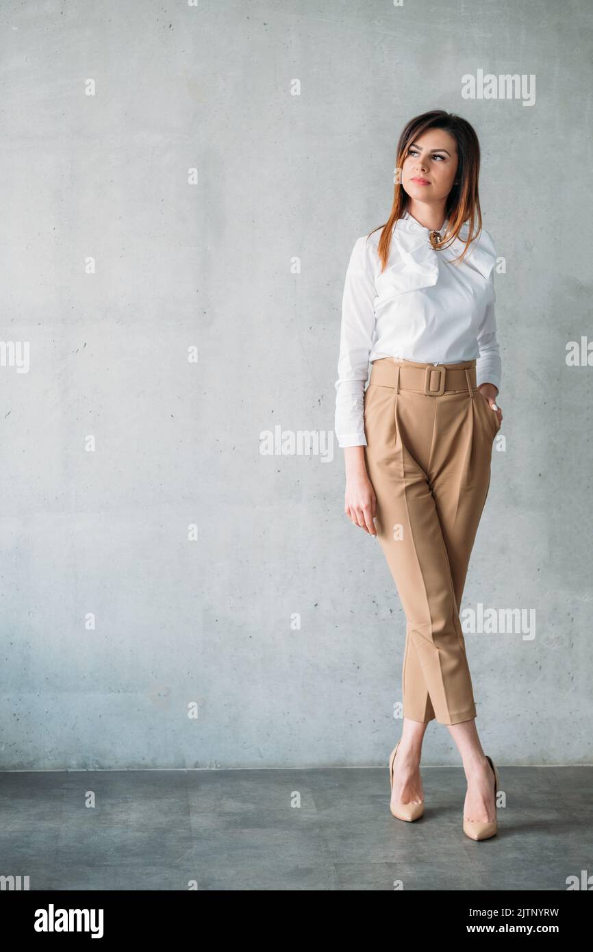 Woman crossed legs standing office hi-res stock photography and images ...