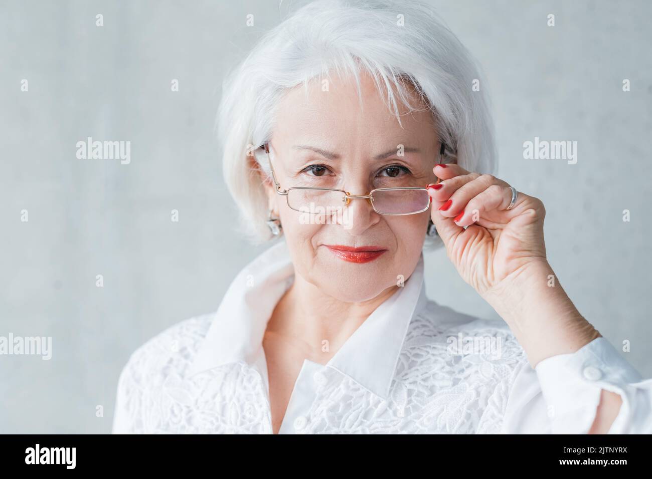 senior business woman evaluative self assured lady Stock Photo