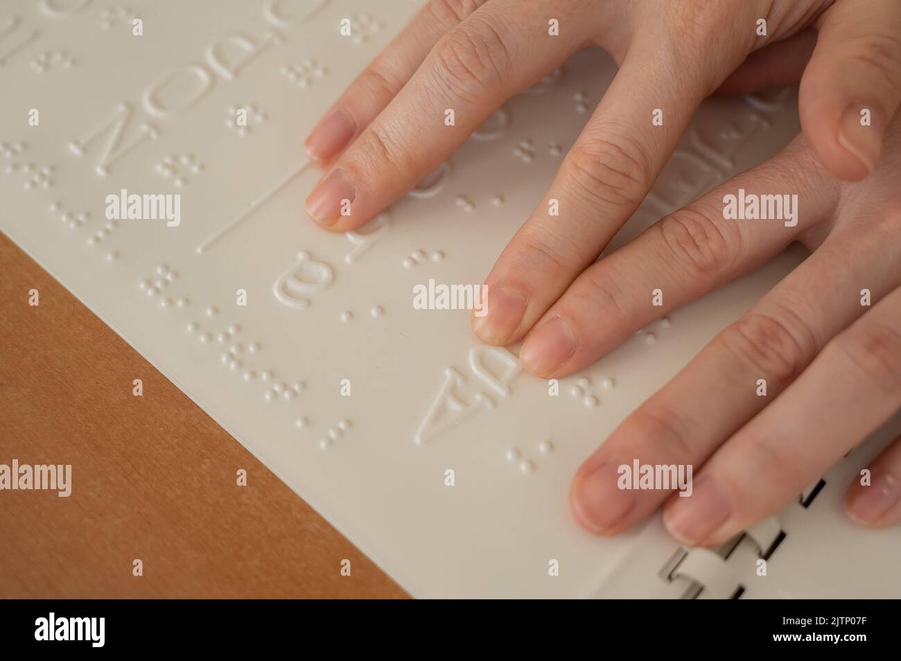 A woman learns the Braille alphabet using a decoder Stock Photo Alamy