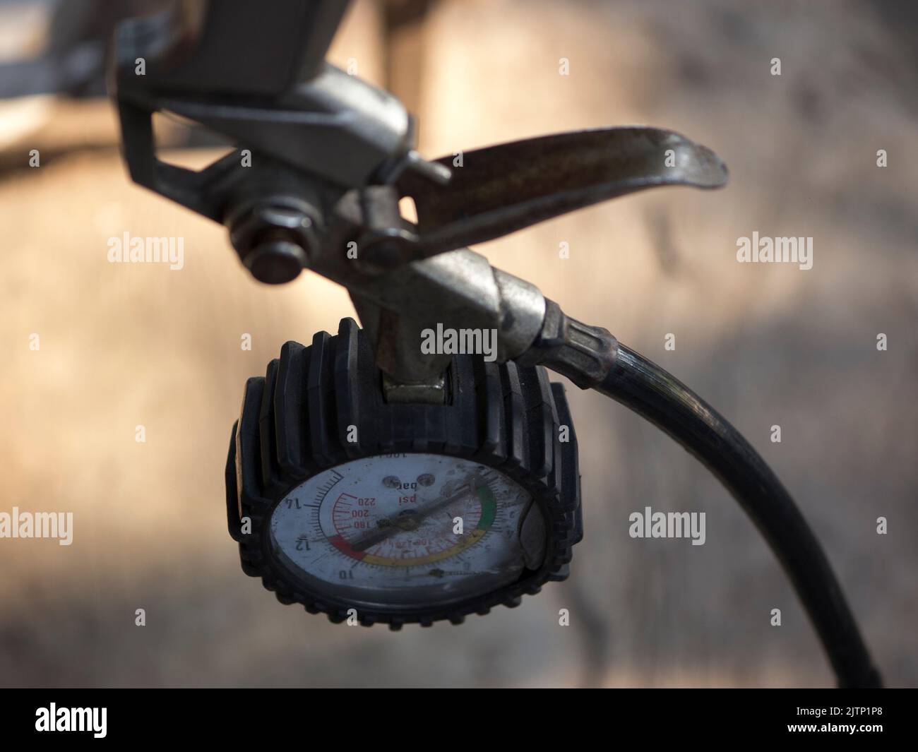 Hand pneumatic tire inflator gun with the pressure gauge on Blurry