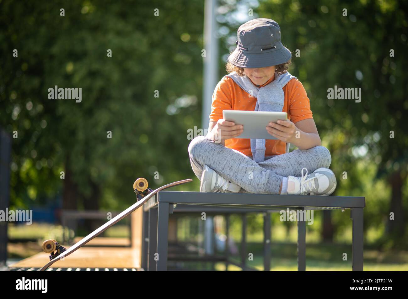 Premium Photo  Calm adolescent with his gadget sitting outdoors