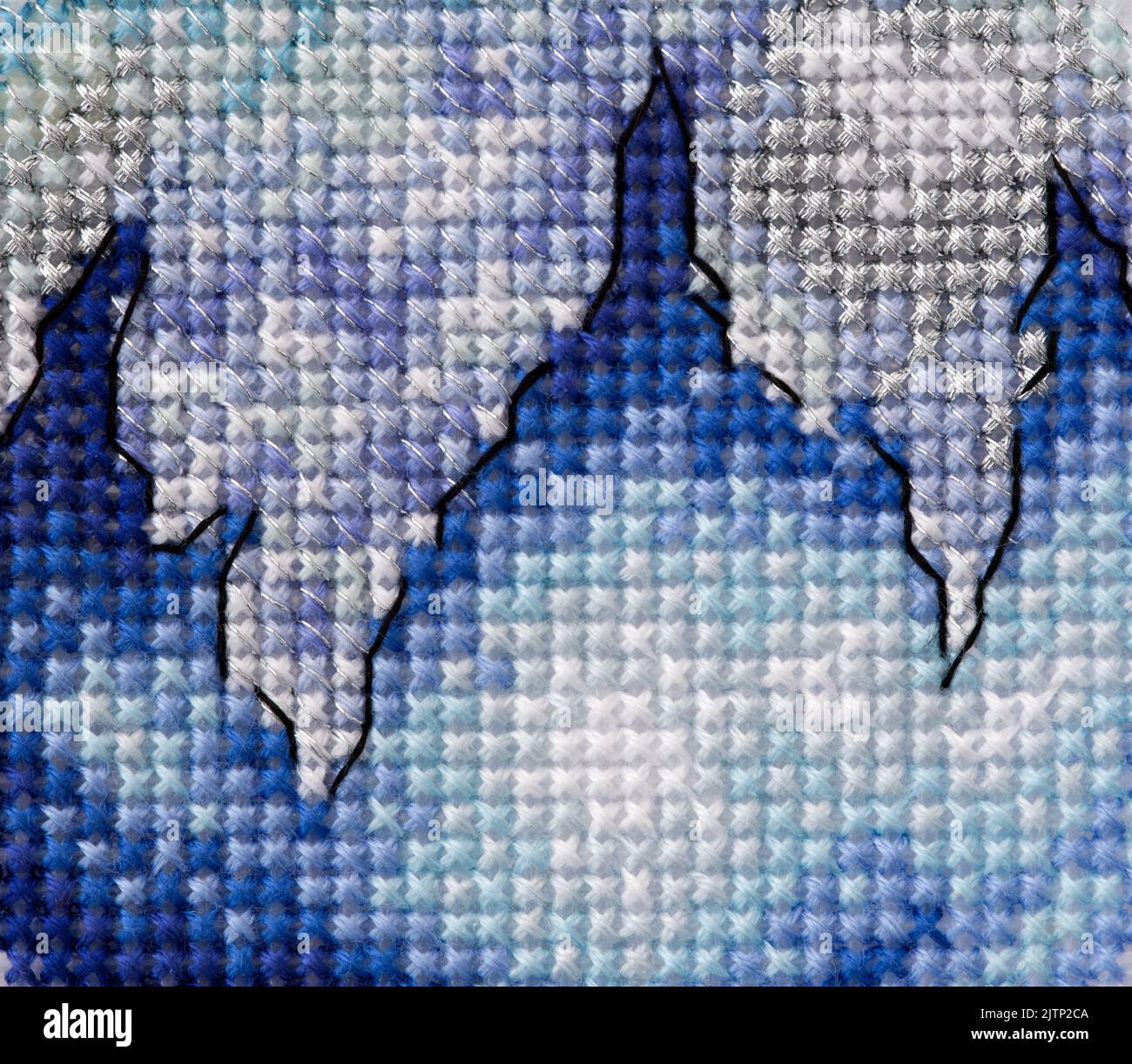 Blue, white and silver cross stitch background. Close-up Stock Photo