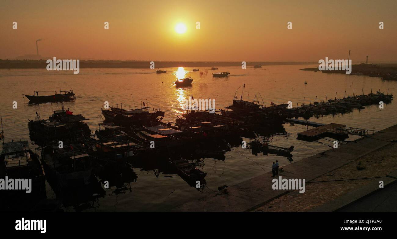 DONGYING, CHINA - SEPTEMBER 1, 2022 - Policemen patrol a dock in the early morning in Dongying city, Shandong province, China, Sept 1, 2022. Stock Photo