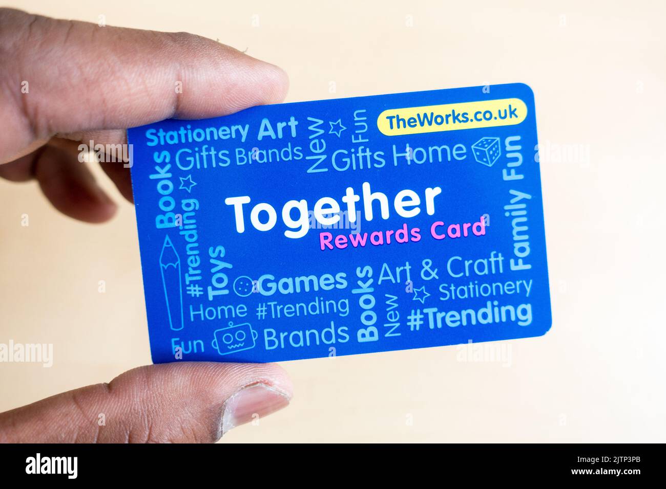 Adult male holding TheWorks stationary store reward card Stock Photo