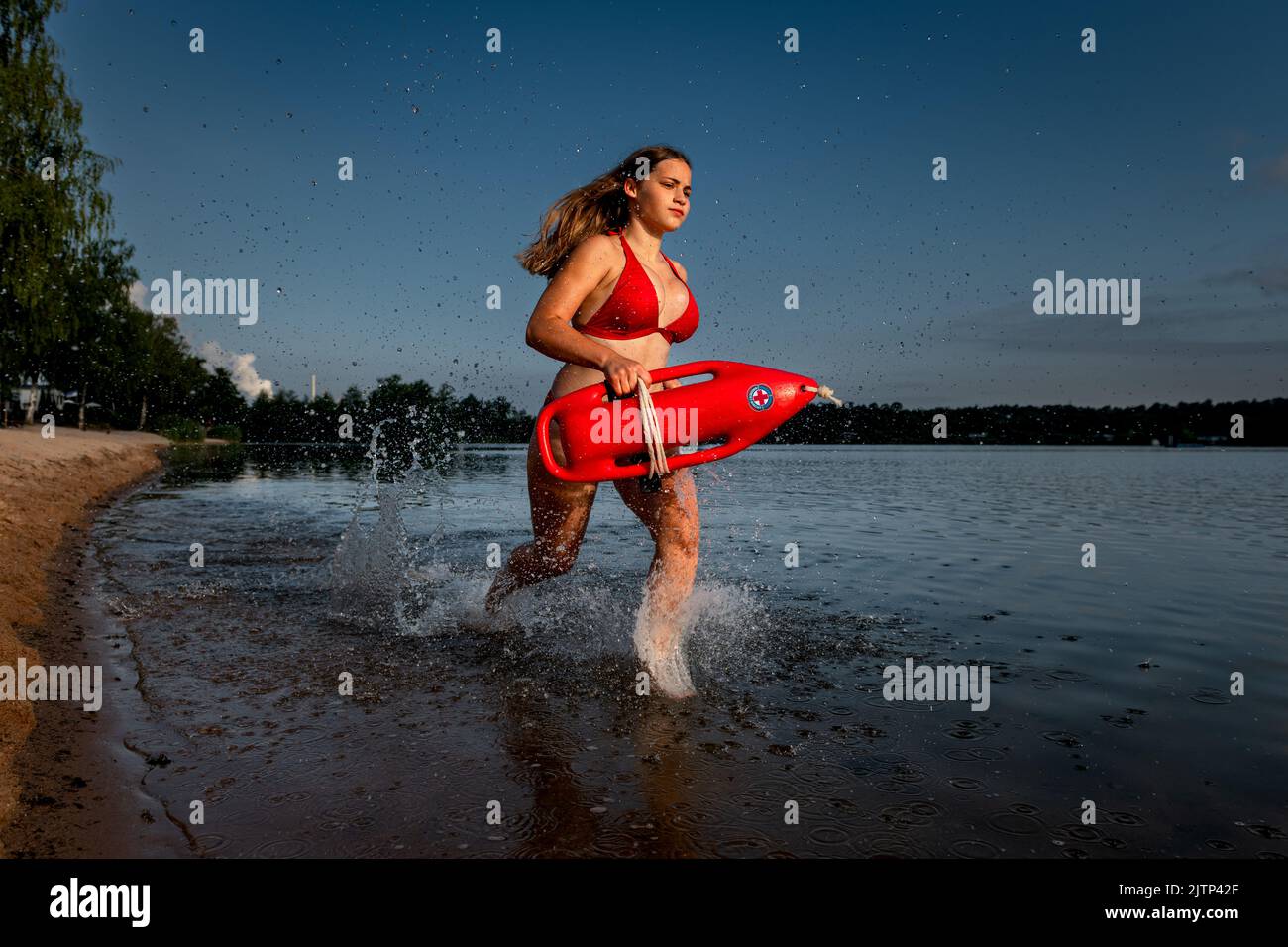 Water rescue with a lifebuoy running into the water. Stock Photo