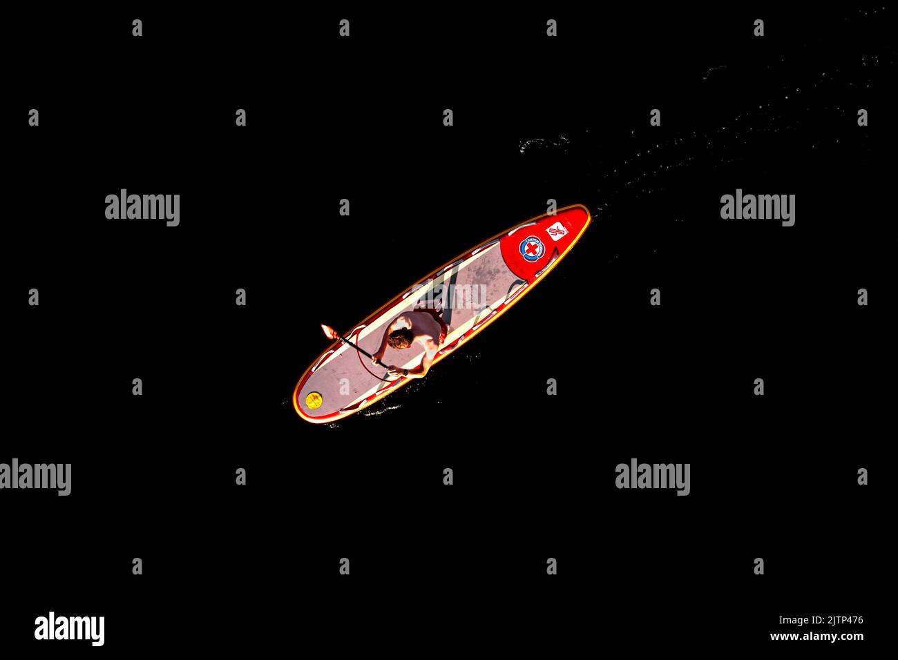 Aerial shot of a lifeguard on a Stand Up Paddle. Stock Photo