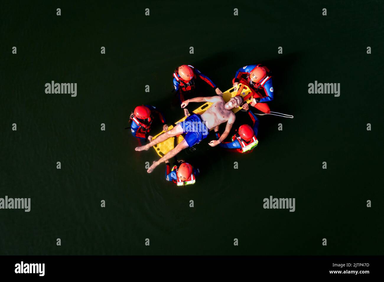 Water Rescue Team operating a spine board for transporting a casualty. Stock Photo