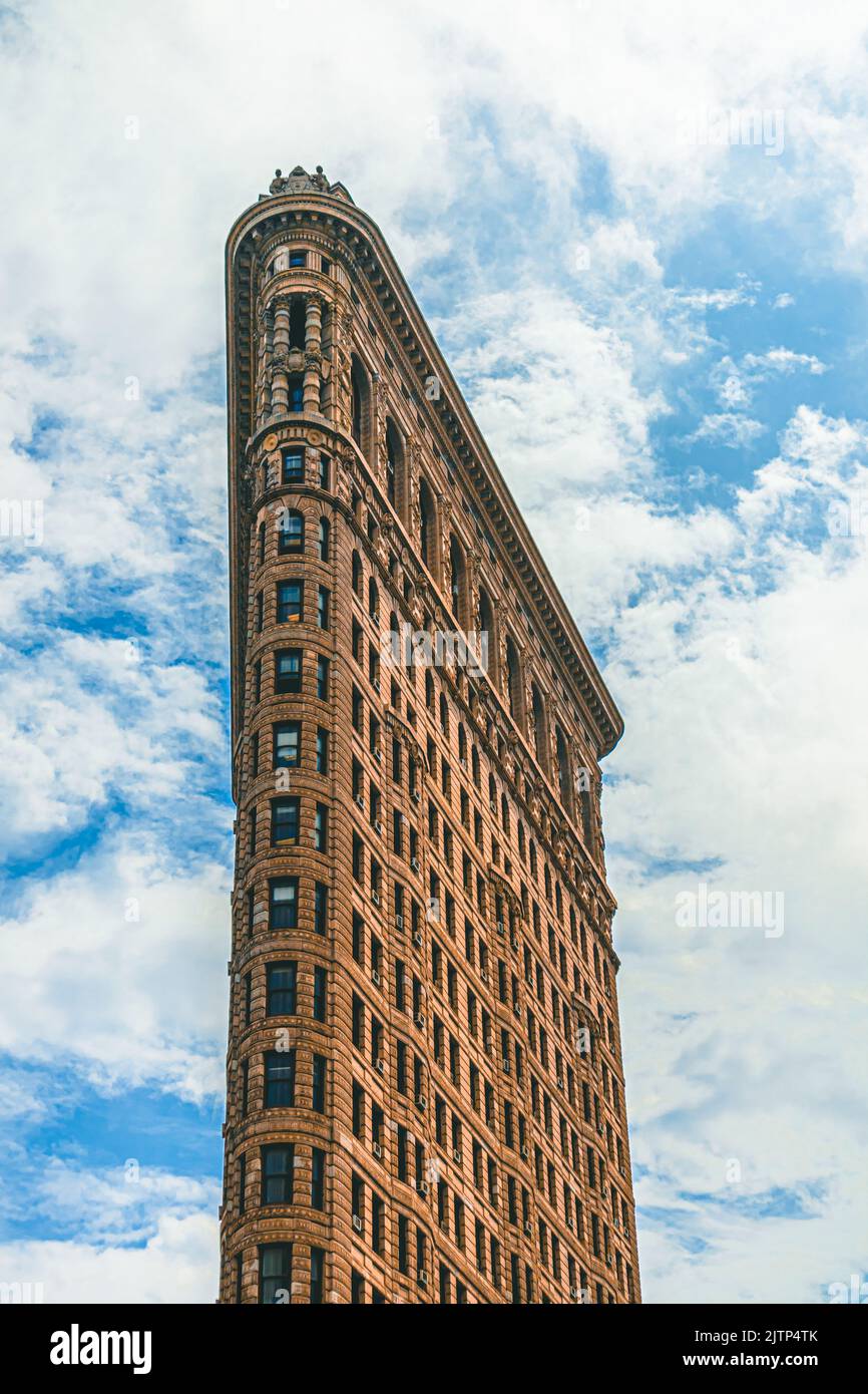 View of Flatiron Building in downtown Manhattan, New York City. The Flatiron building has been featured in multiple movies and is a popular landmark. Stock Photo