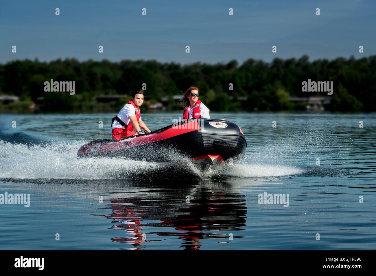 Water rescue crew on patrol with a motorboat. Stock Photo