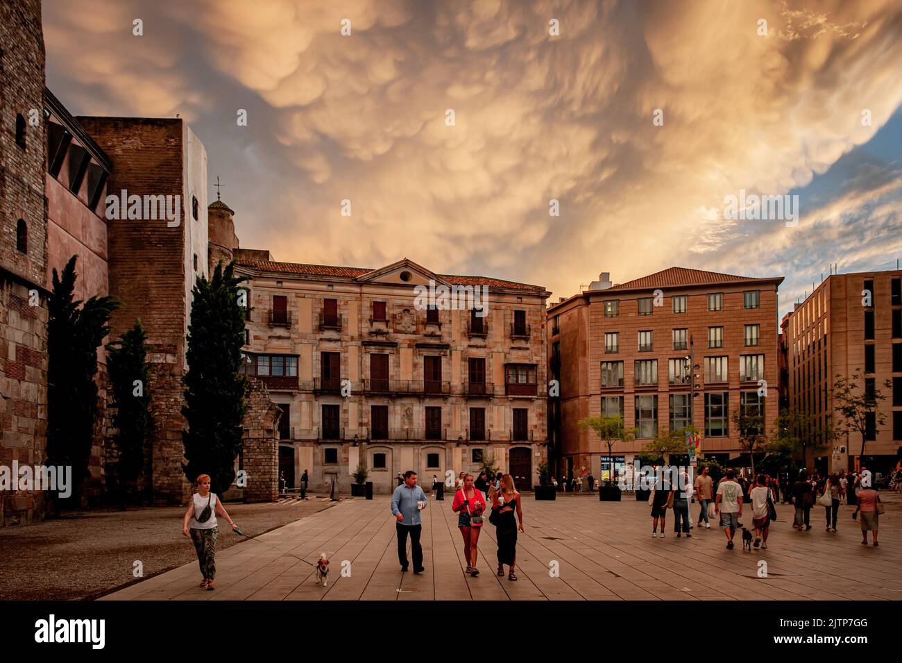August 31, 2022, Barcelona, Spain: People walk along Cathedral square in the Gothic Quarter of Barcelona under a cloudy colorful sky after a day of sun and heavy rains. Credit: Jordi Boixareu/Alamy Live News Stock Photo
