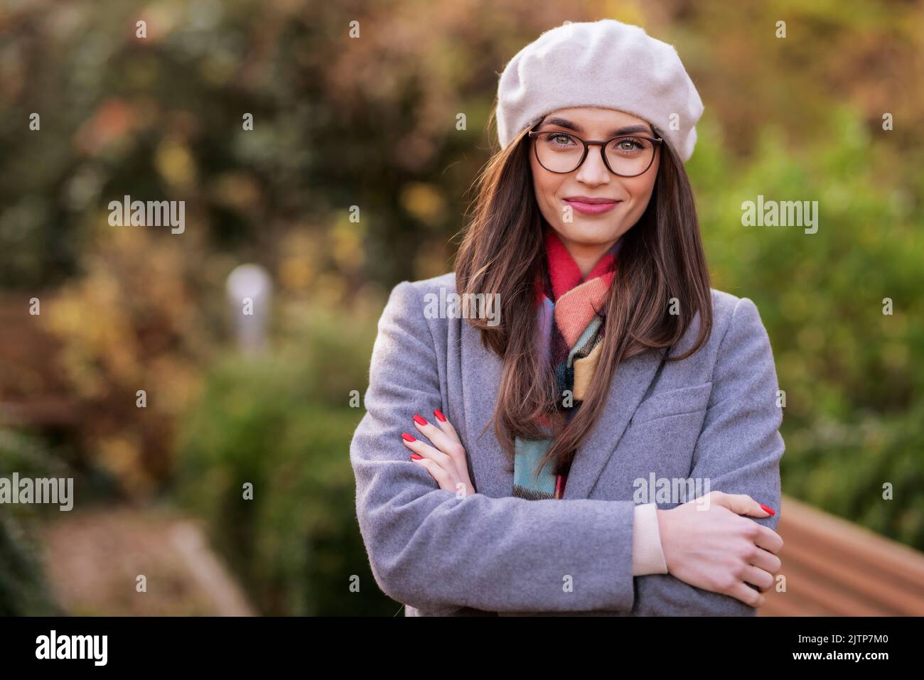 Portrait of attractive young woman wearing beret hat and wool coat ...