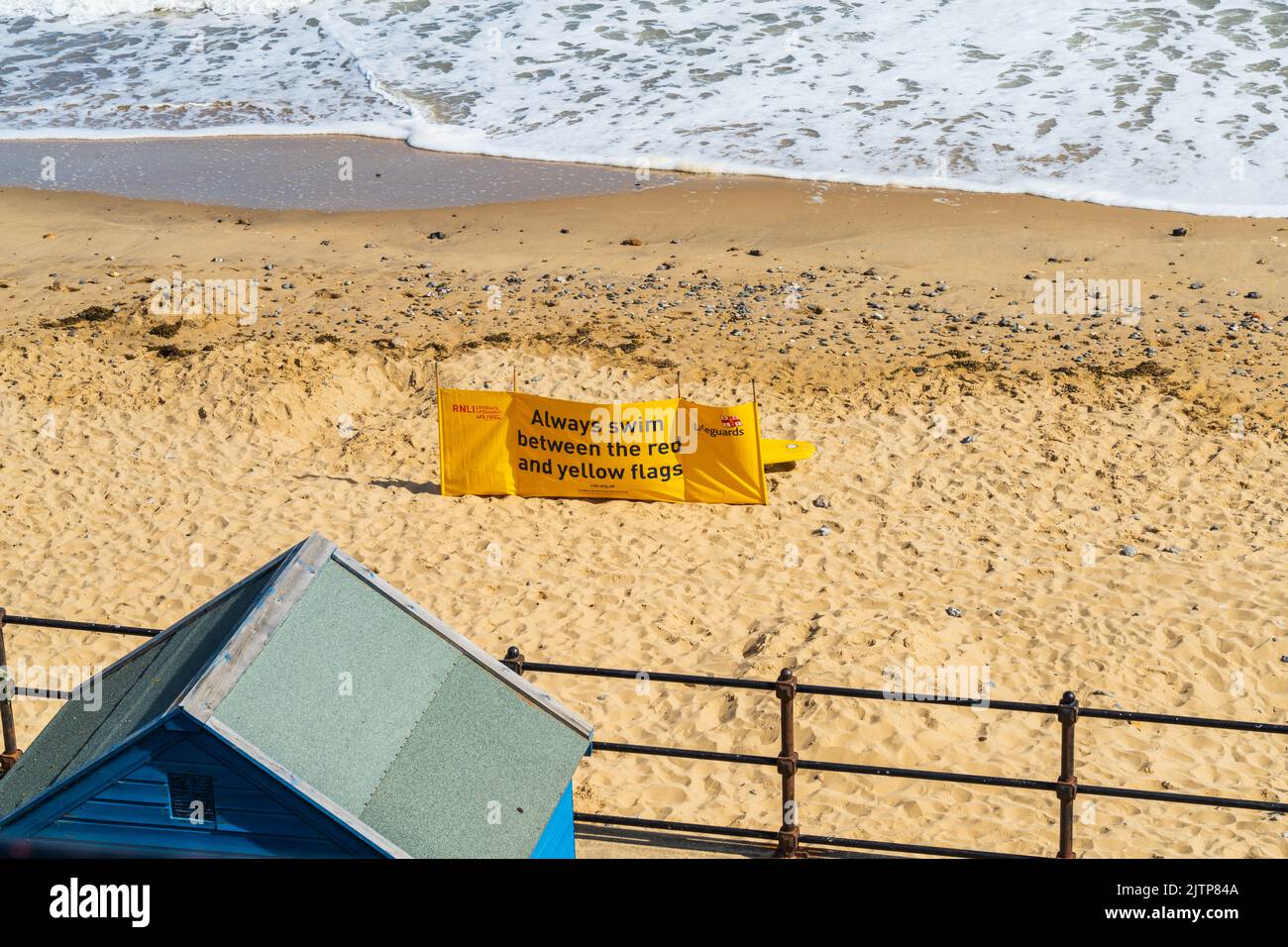 Beach safety flag on Mundesley Beach in North Norfolk in the UK informing visitors where it is safe to swim in the Sea Stock Photo