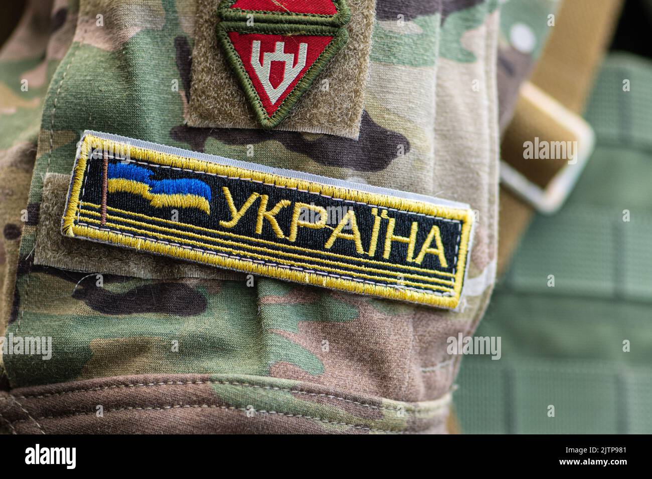 Flag of Ukraine with trident, Ukrainian Army or Armed Forces on a patch of a soldier military uniform, close up Stock Photo