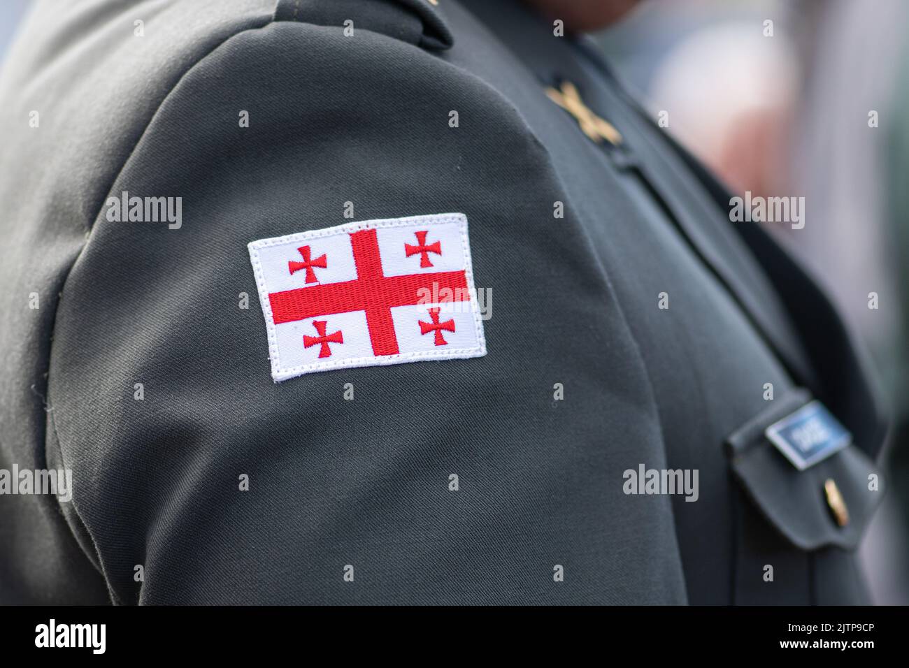 Flag of Georgia, Georgian Army or Armed Forces on a patch of a soldier military uniform, close up Stock Photo