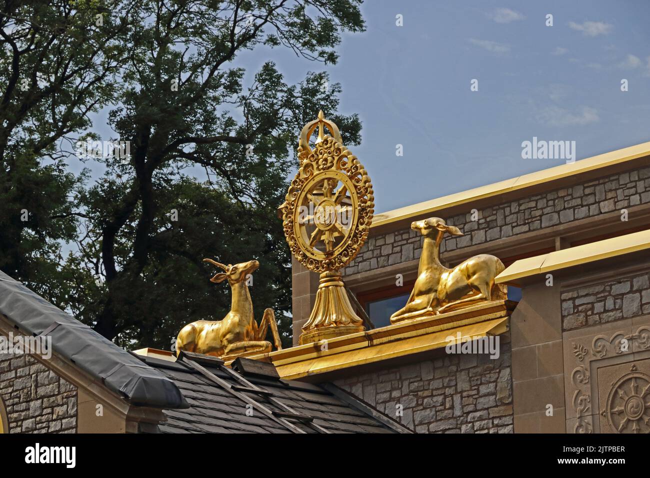 Deer and Dharma Wheel on roof of Kadampa Temple of World Peace, Ulverston Stock Photo