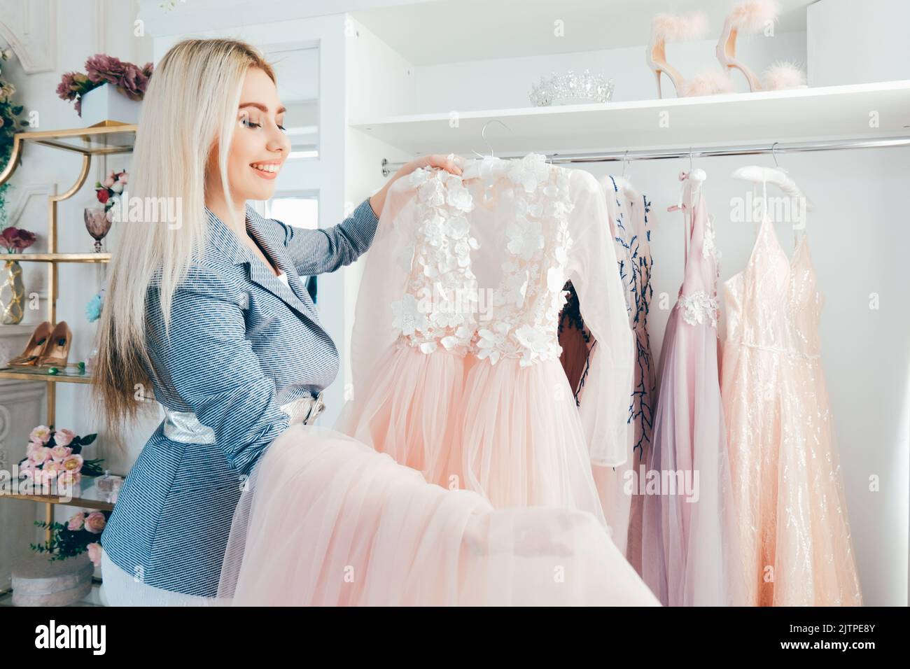 Smiling fashion designer presenting dress hi-res stock photography and ...