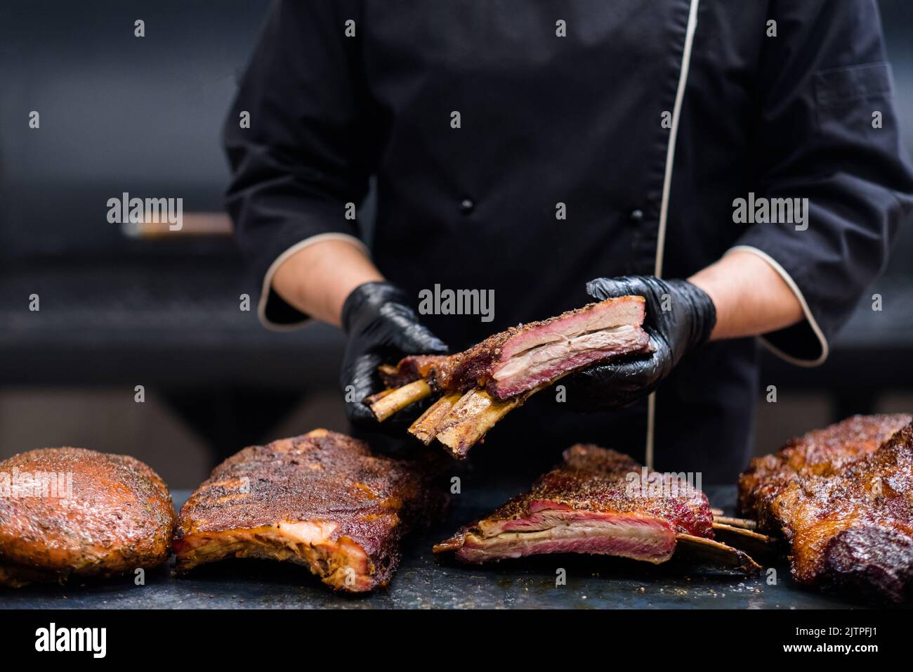 catering service smoked beef ribs kitchen table Stock Photo